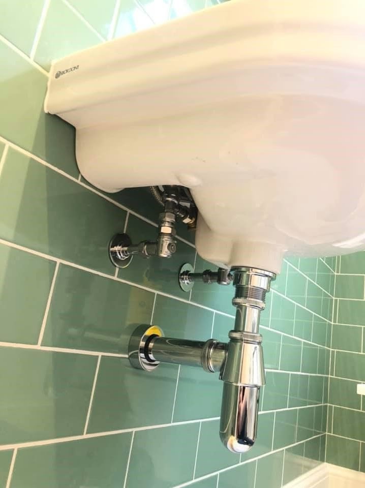 Sage green metro brick shower room